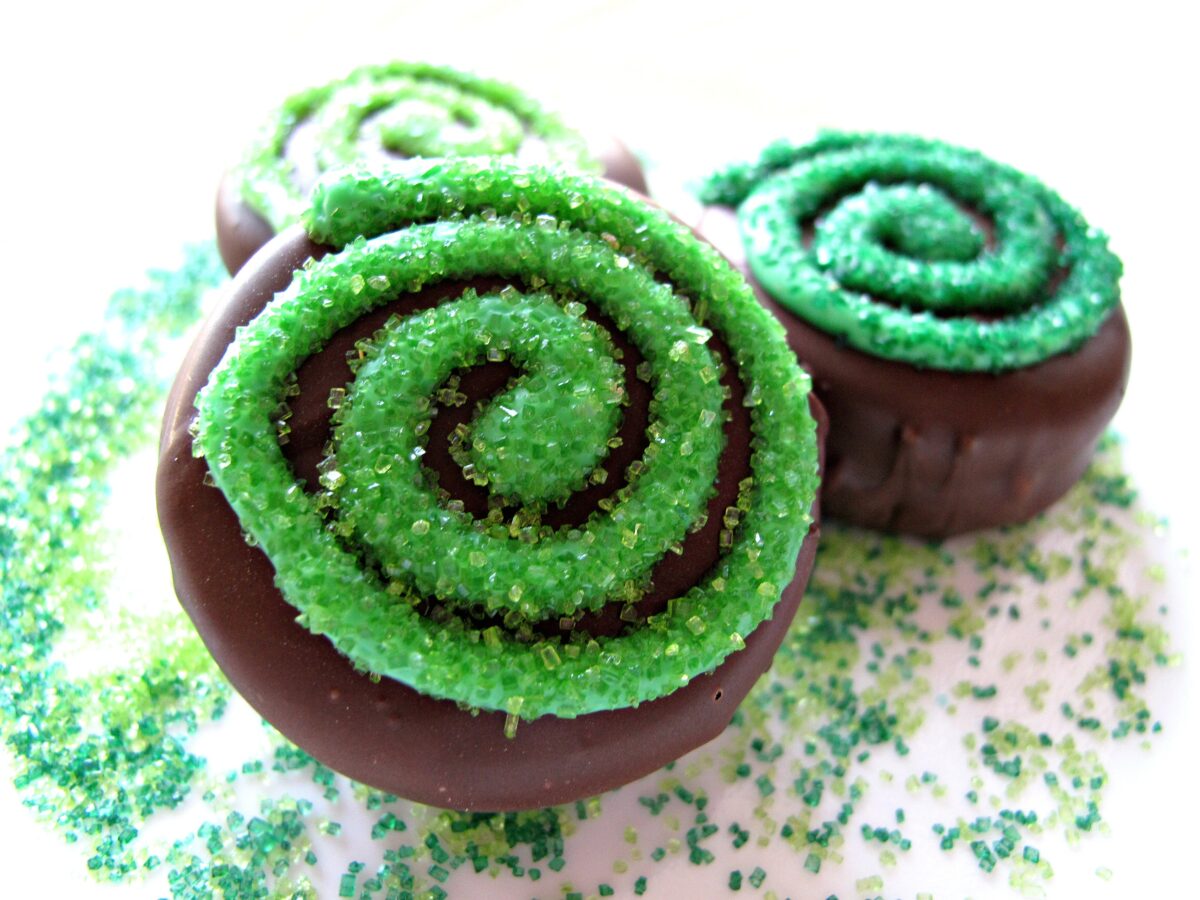 Closeup of swirl decorated chocolate coated cookies.