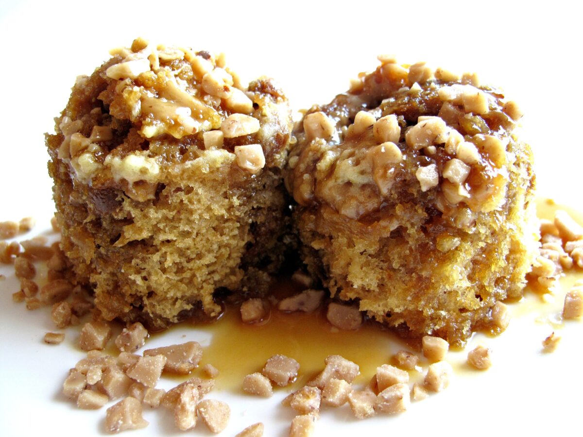 Two mug cakes on a plate sprinkled with toffee bits.