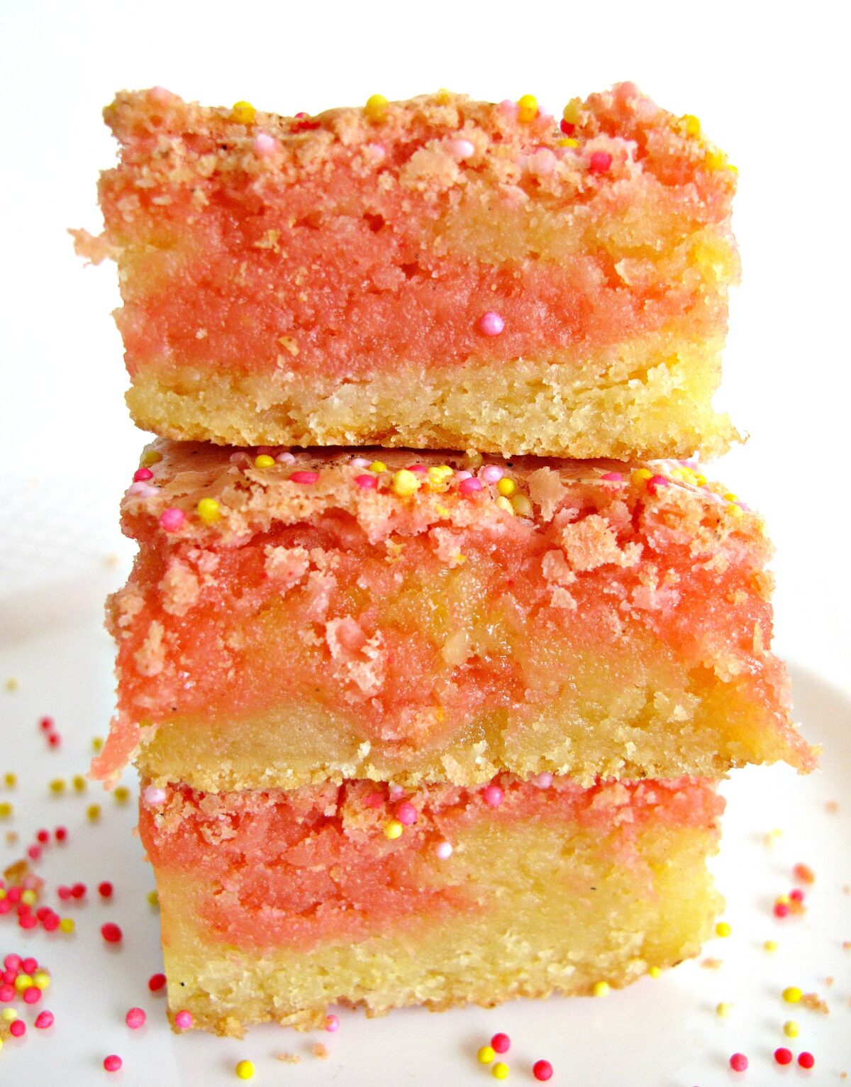 Stack of Strawberry Lemonade Bars showing thick yellow and pink striped interiors.