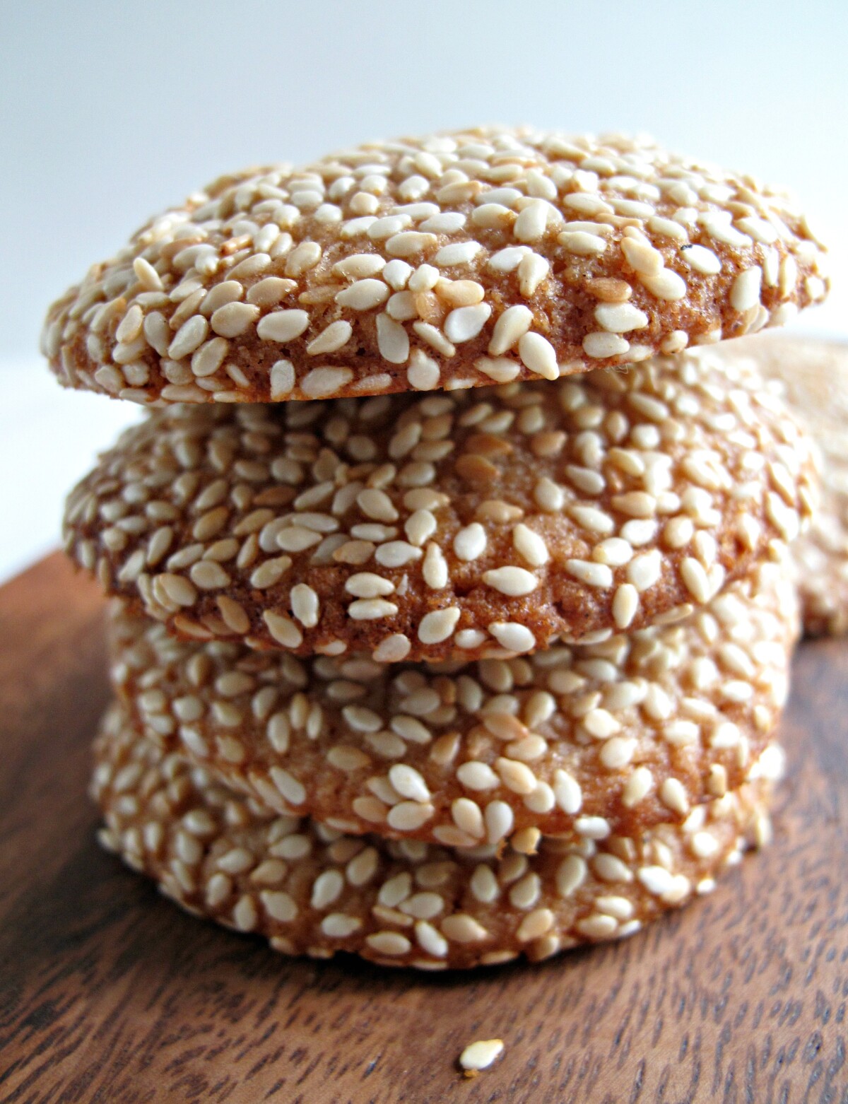 Stack of sesame coated cookies shown from the side.