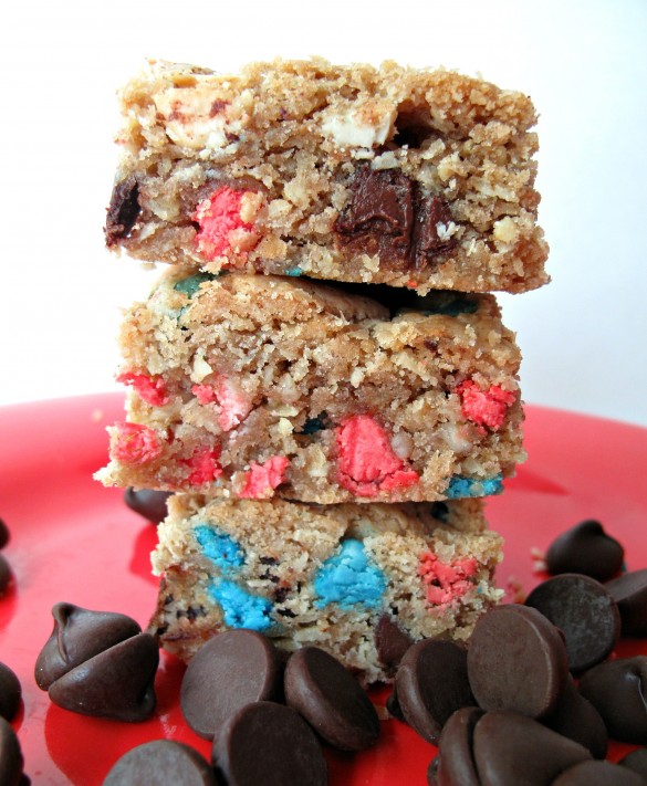 Chocolate Chip Oatmeal Cookie Bar in a stack with red and blue colored chips.