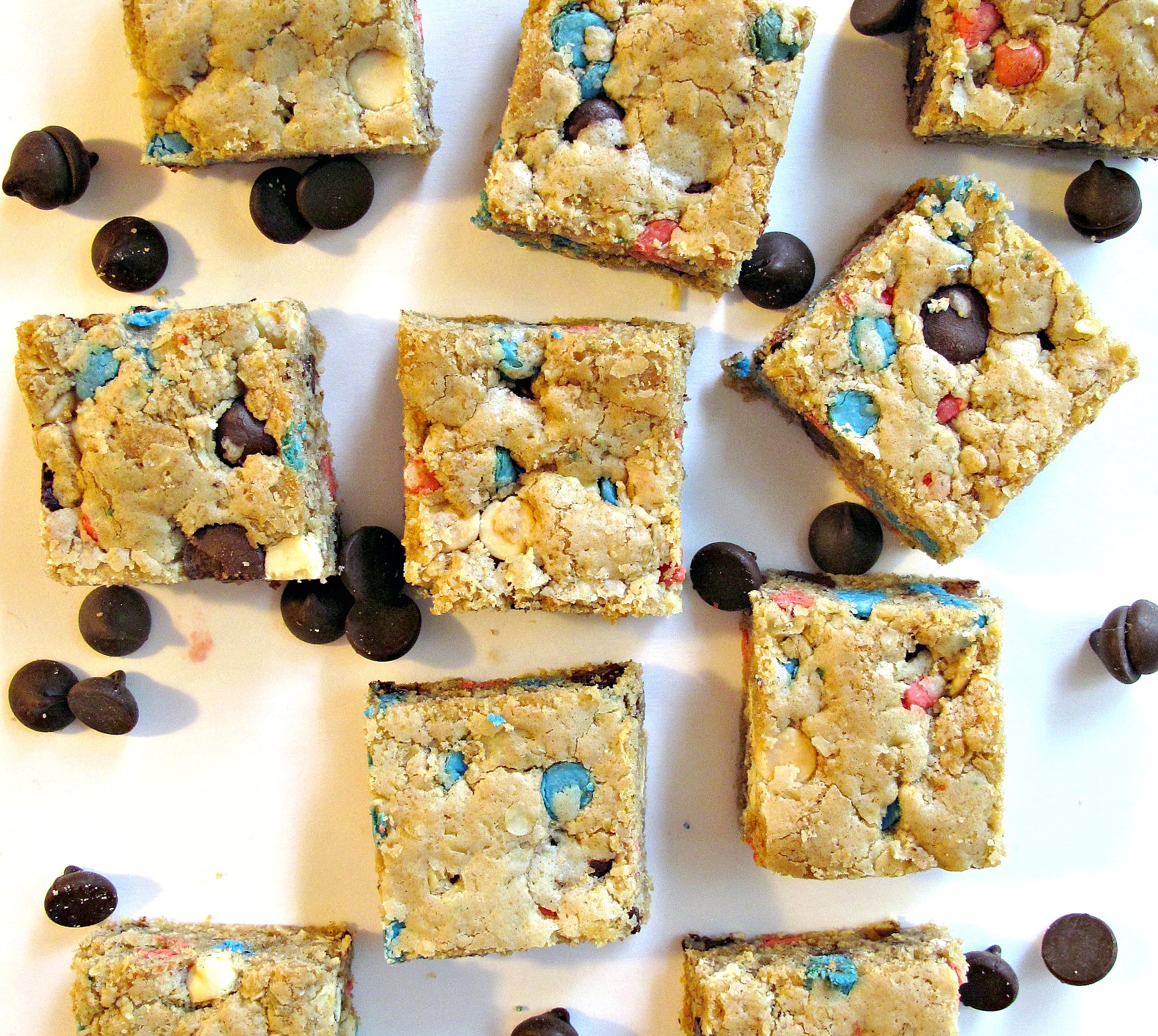 Oatmeal Cookie Bars  with red, blue, and chocolate chips peaking through the dough.