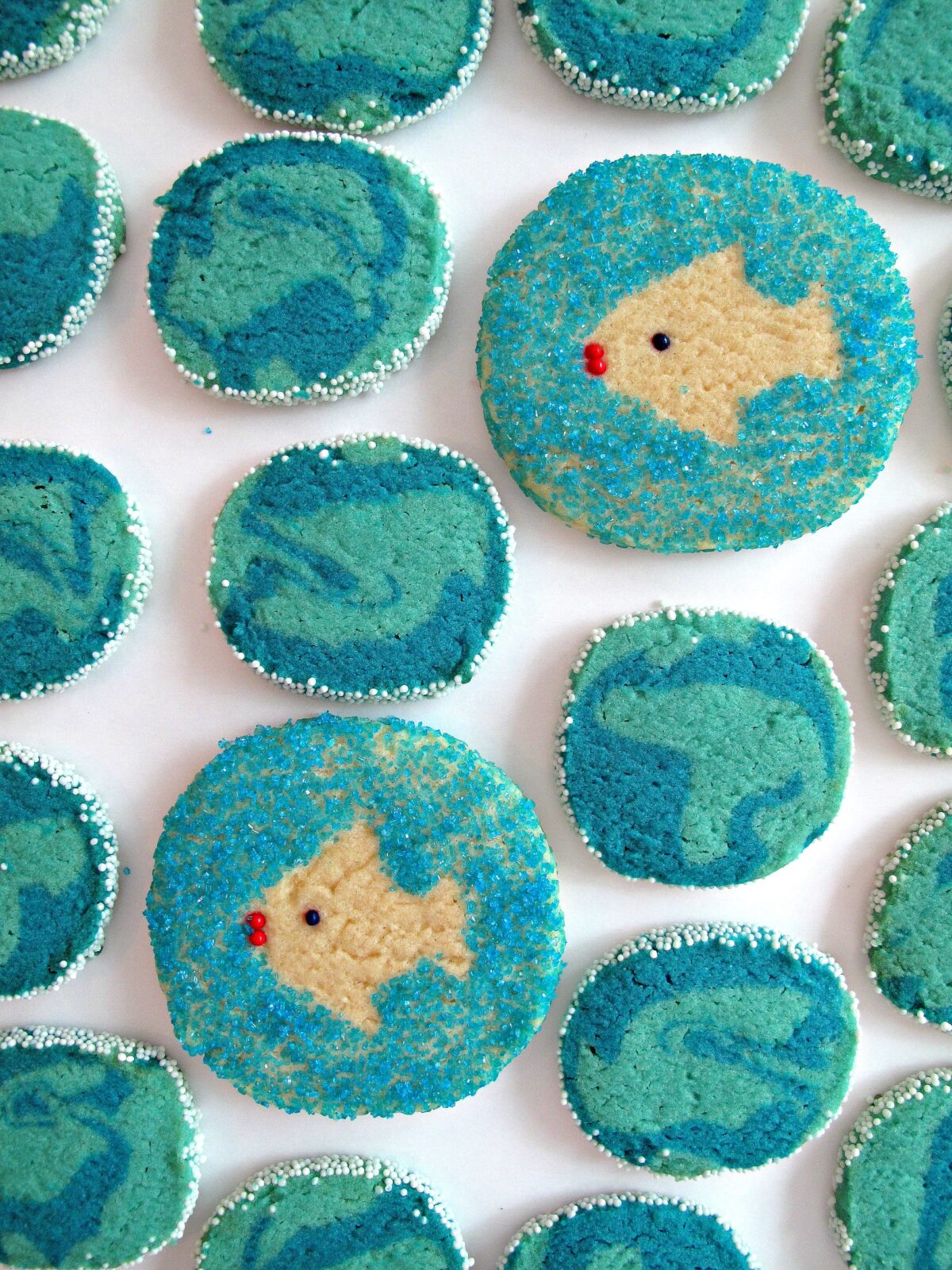 Blue sugar cookies with a fish shape stenciled in the center.