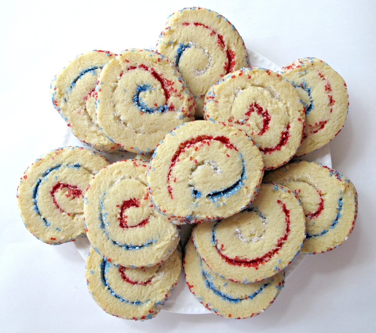 Spiral Sparkler Cookies with white dough rolled up around red,white,blue sparkling sugar. 