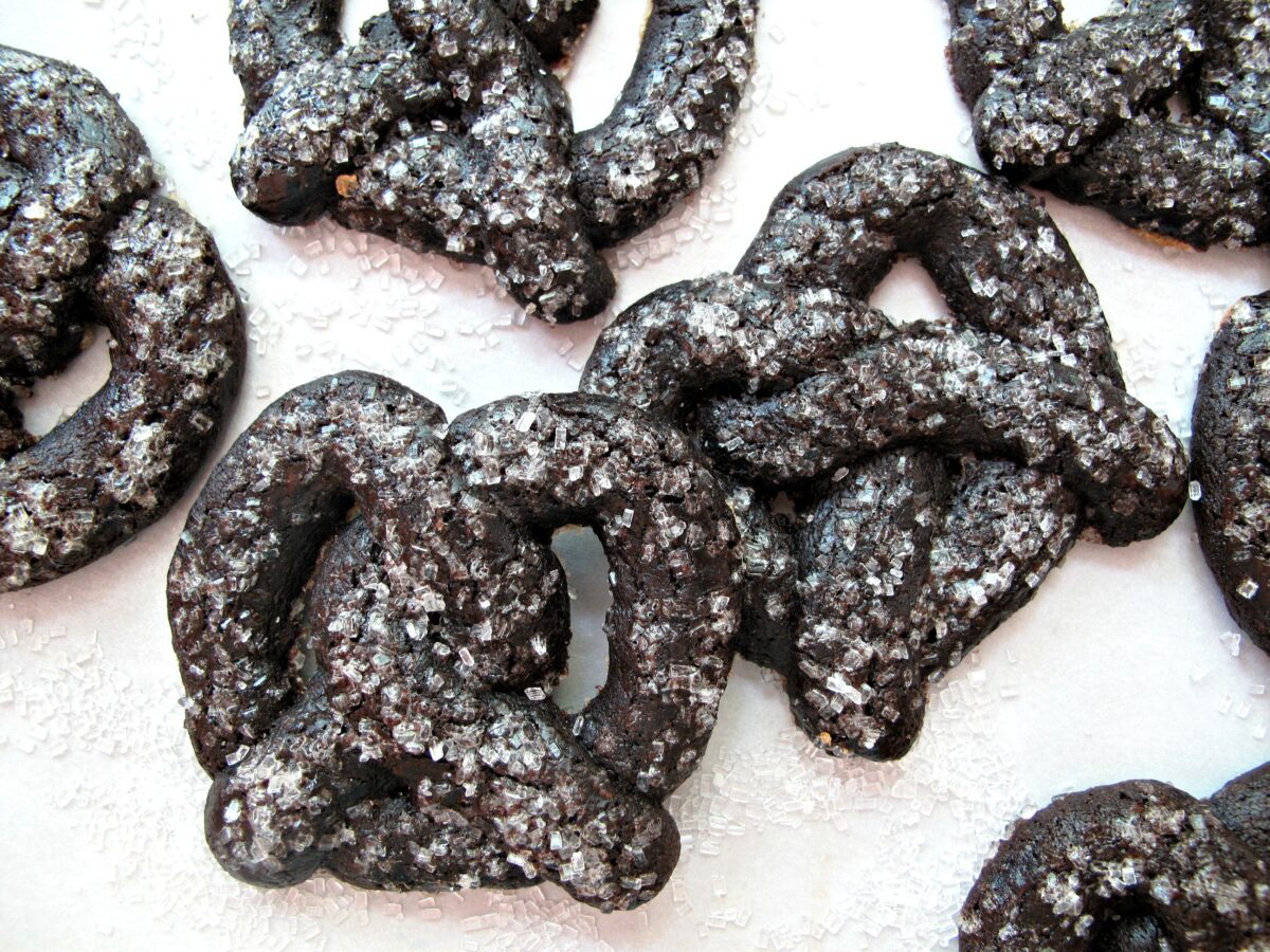 Closeup of sugar encrusted, pretzel shaped chocolate cookies.