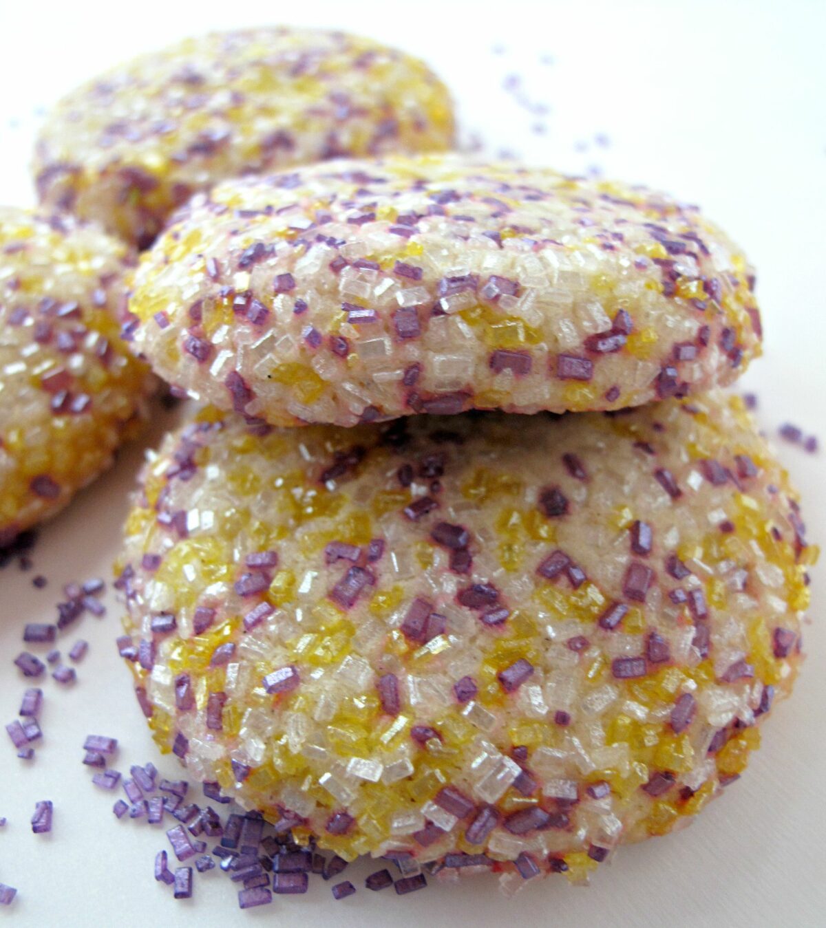 Two thick cookies coated in large crystal decorating sugar.