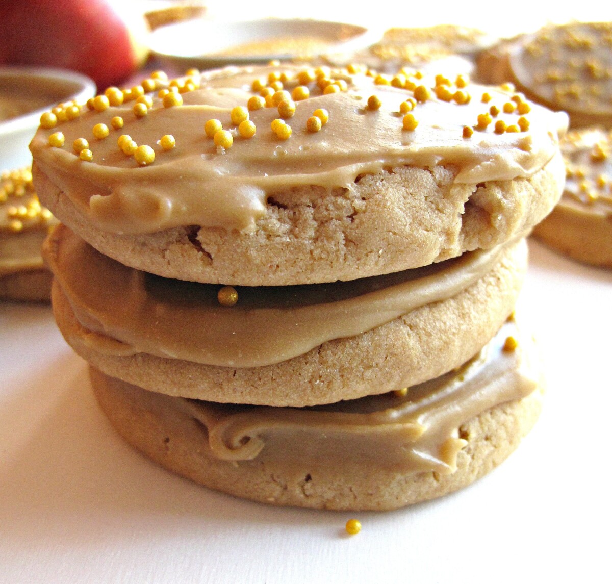 Stack of 3 cookies from the side to show the thickness of the caramel iced cookies.