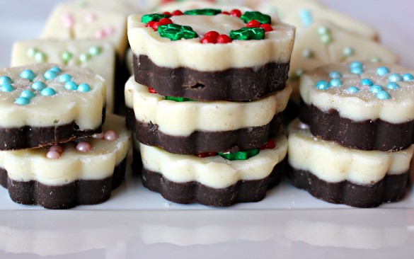 Snowflake and Christmas Wreath Fudge seen from the side to show the two layers of white chocolate on the top and milk chocolate on the bottom.