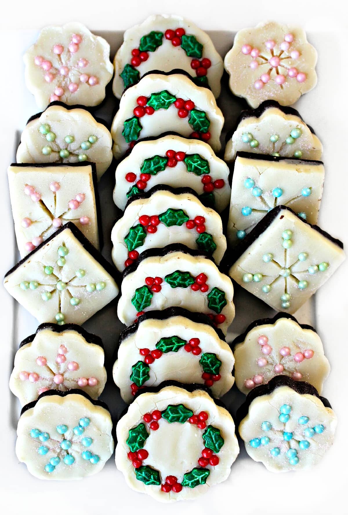 Double decker fudge decorated like snowflakes and wreaths.