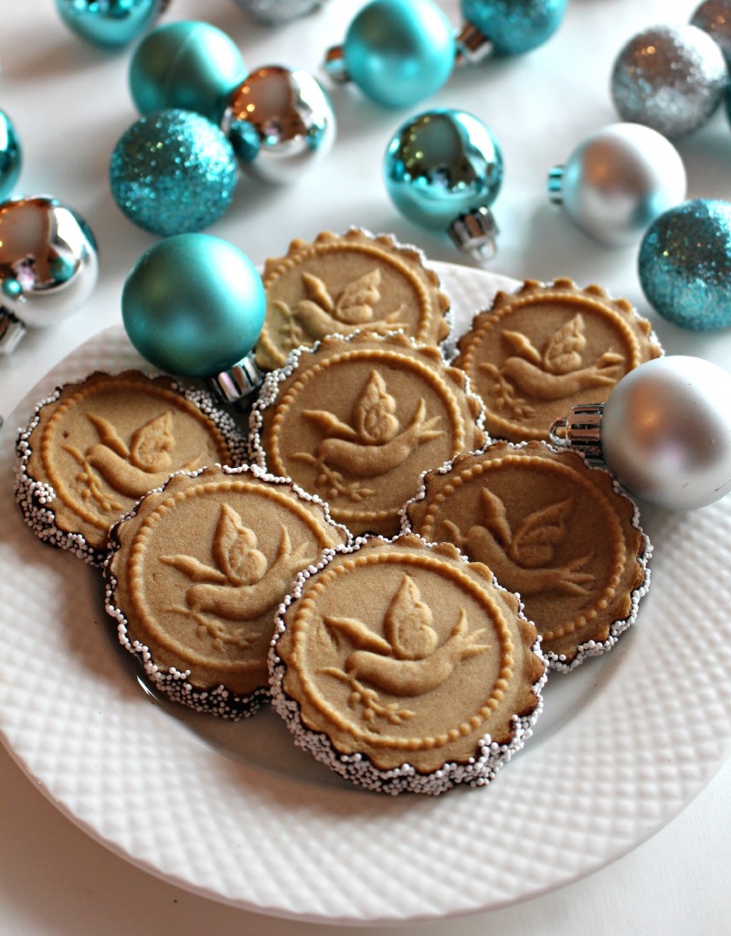 Honey Gingerbread Cookies on a white plate with silver and blue ornaments in background