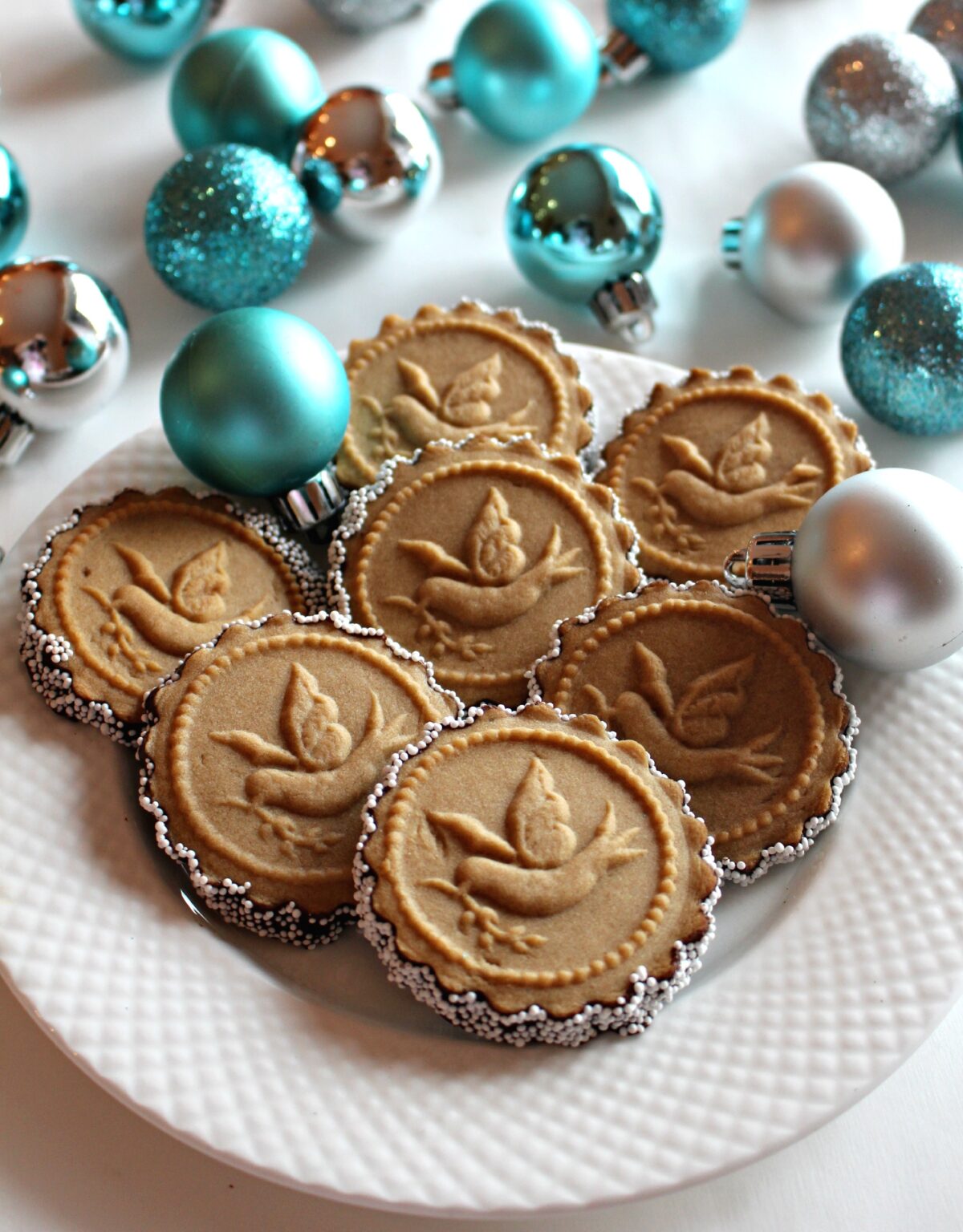 Round Honey Gingerbread Cookieswith scalloped edges, stamped with a dove.