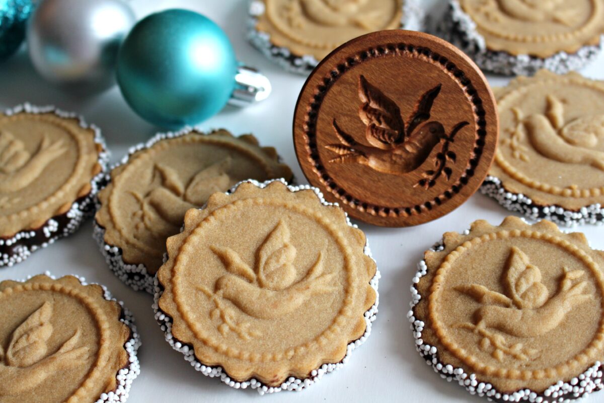 Honey Gingerbread Cookies and a wooded cookie stamp with impression of dove with olive branch.