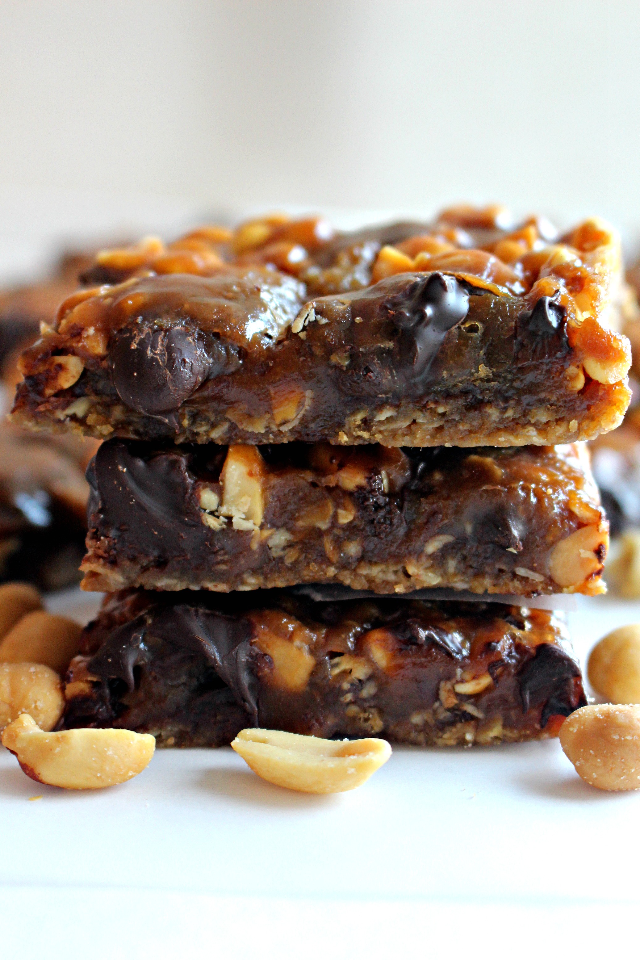 Stack of chewy caramel chocolate chip bars with peanuts.