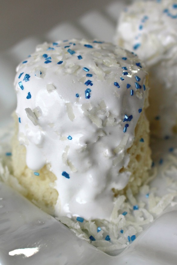 Coconut Snowball Mug Cake covered in melted marshmallow cream and blue and white sugar