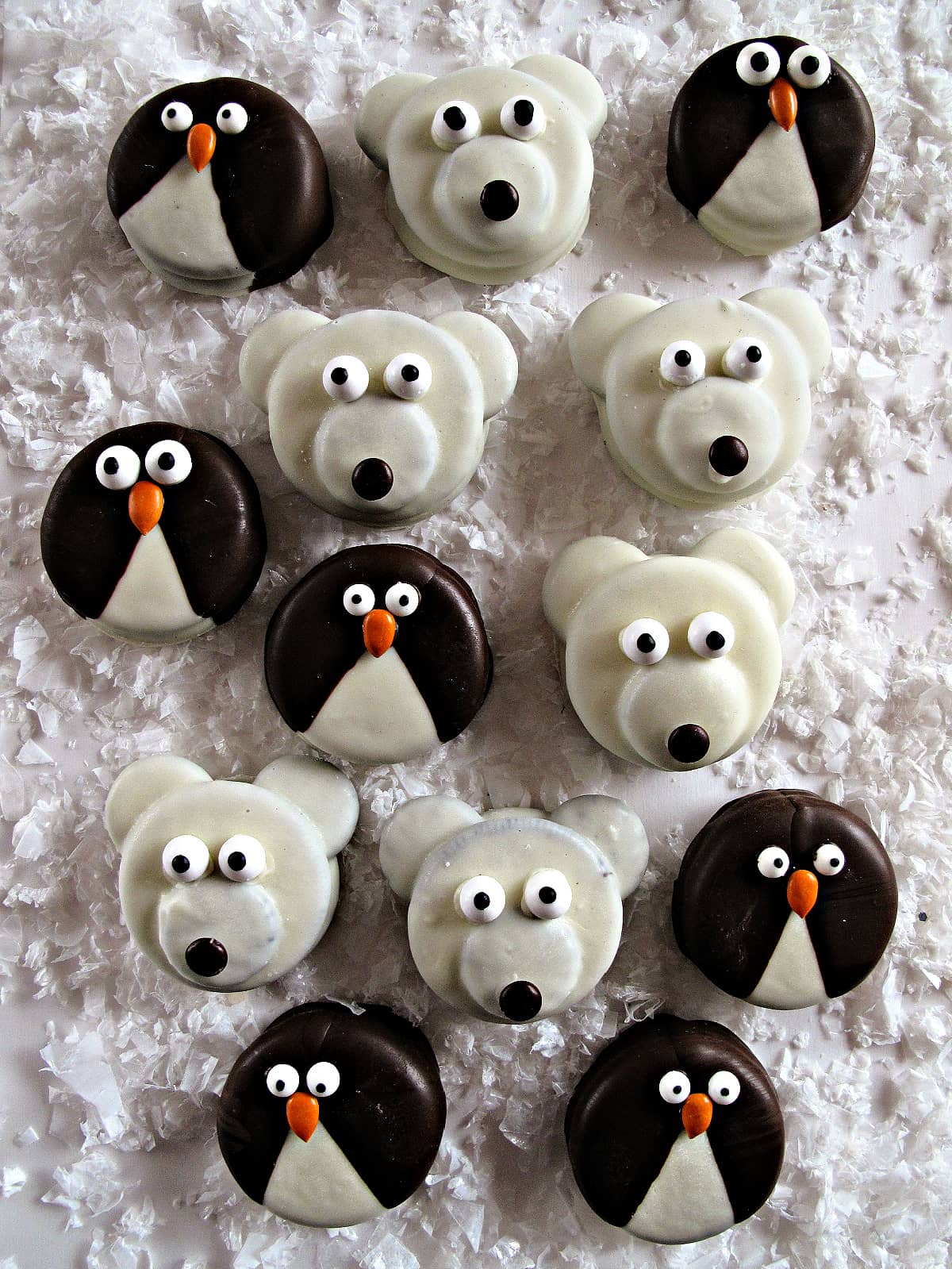 Penguin and Polar Bear Oreos on a white surface with artificial snow.