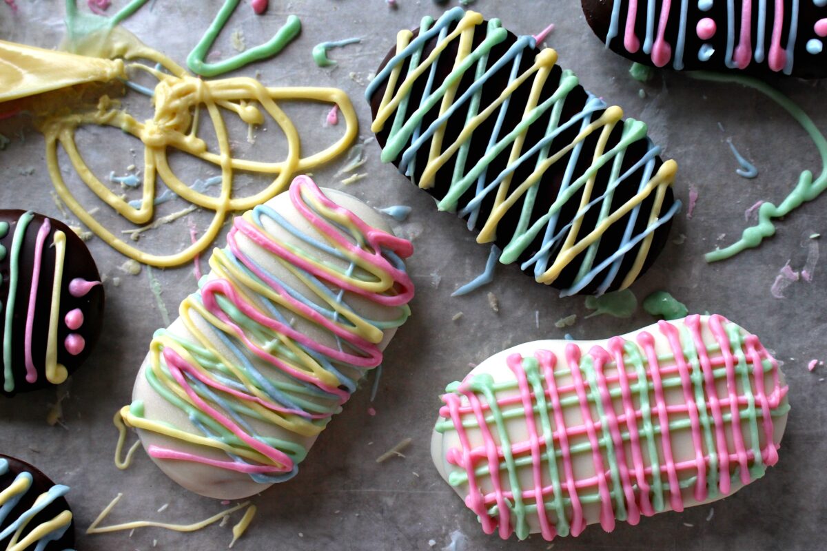 Close up of decorated chocolate covered Milano cookies.