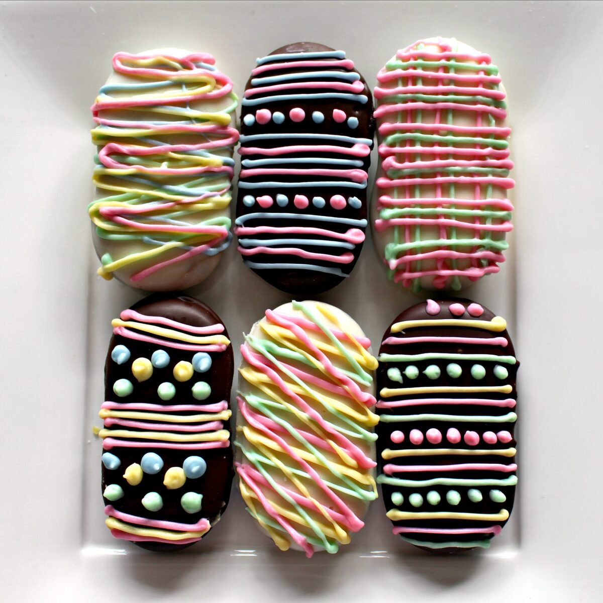 Milano Cookies covered in chocolate and decorated in pastels to look like easter eggs.