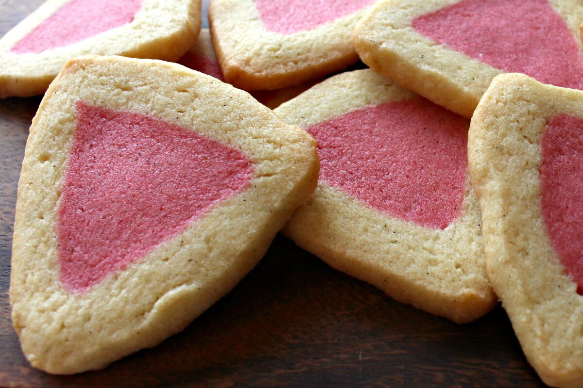 Triangle cookies with pink centers.