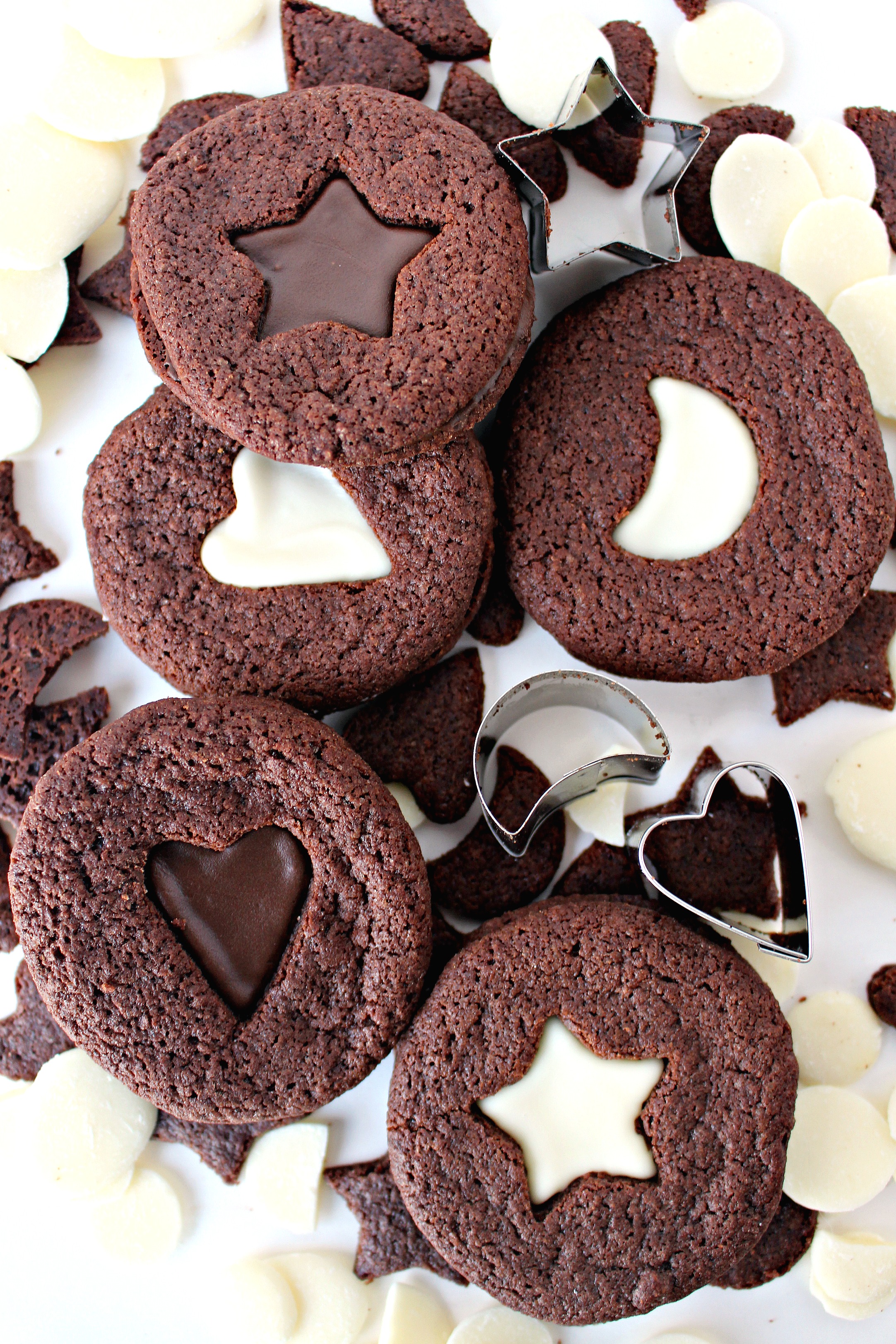  Chocolate Sandwich Cookies with star, heart, and moon cutout centers showing white or dark chocolate filling.