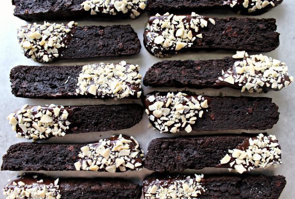 2 rows of dark brown Double Chocolate Passover Biscotti (GF) one end of each dipped in chocolate and coated in almond bits