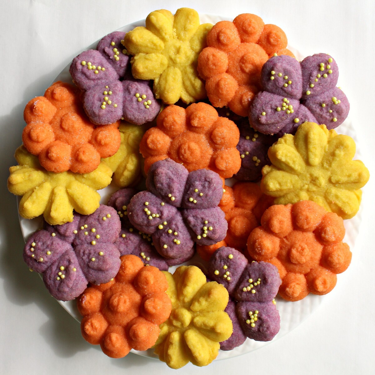 Cookie Press Butter Cookie flowers in orange, purple and yellow.