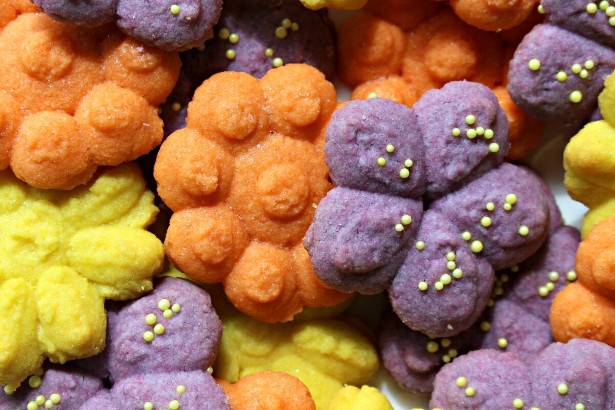 Closeup of pressed butter cookies in flower shapes.
