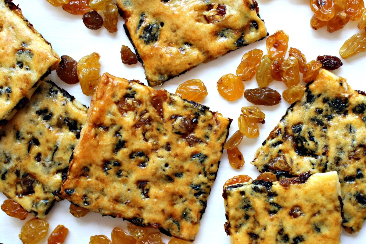 Closeup of biscuit squares and golden raisins.