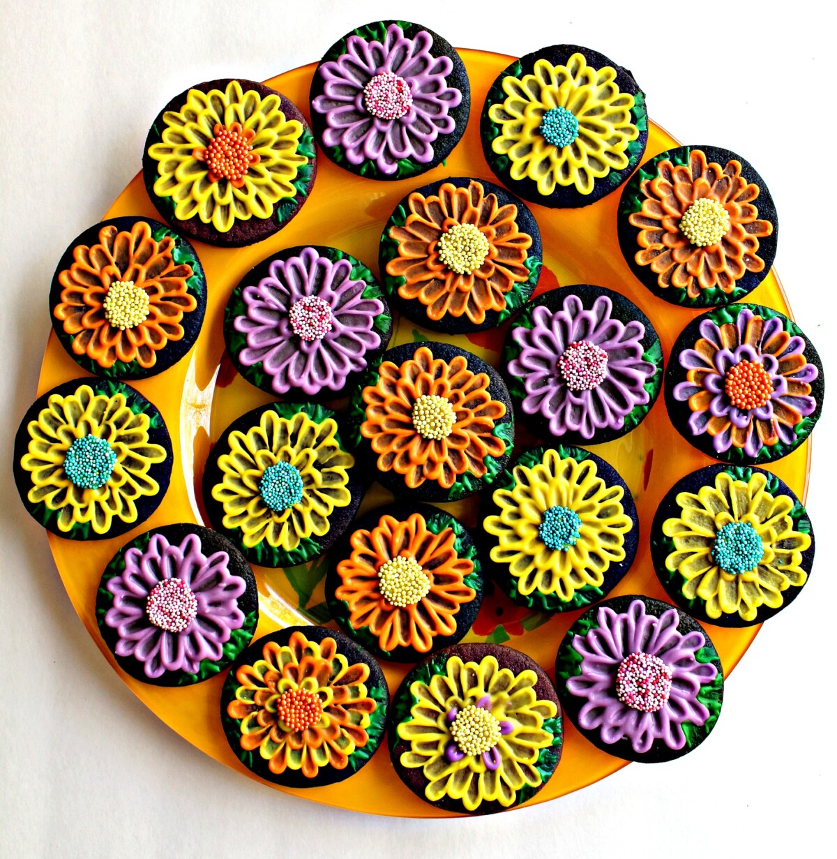 May Flowers Sugar Cookies  in many colors on a round, yellow platter.