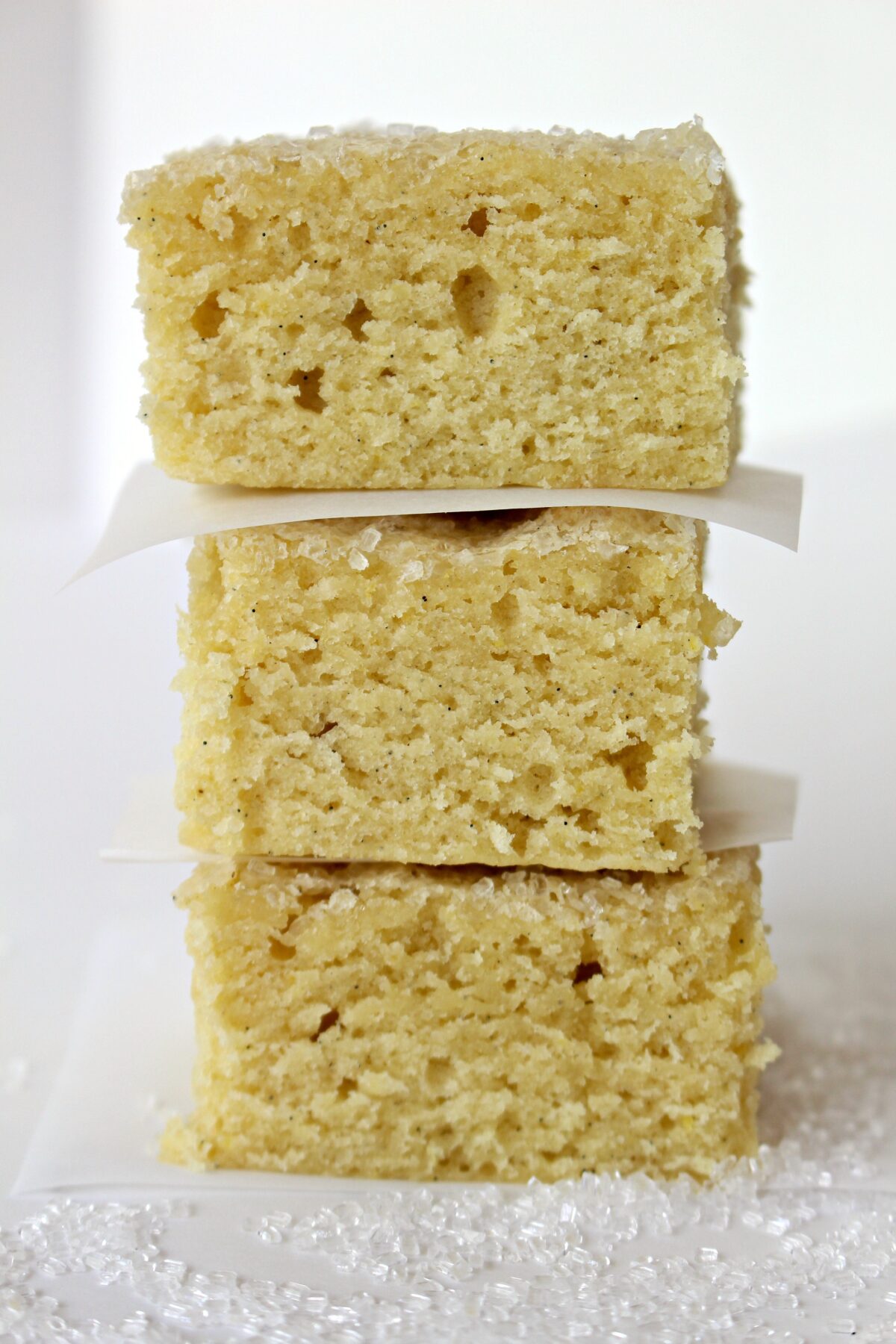 Stack of thick cookie bars with parchment between each bar.