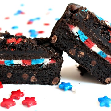 Sliced open brownie with an Oreo cookie in the middle, filled with red, white and blue frosting.
