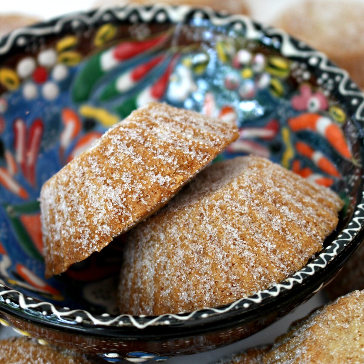 Closeup of fluted sides of two cookies in a Bosnian painted bowl.