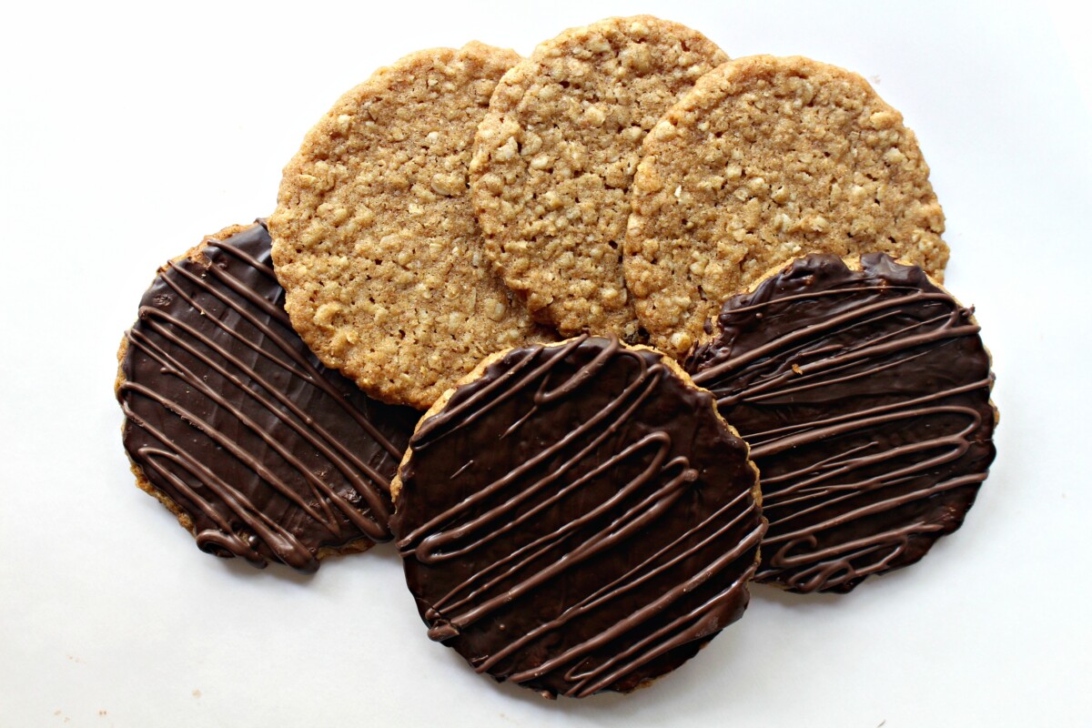 Three oat cookies without chocolate and three with chocolate coating.