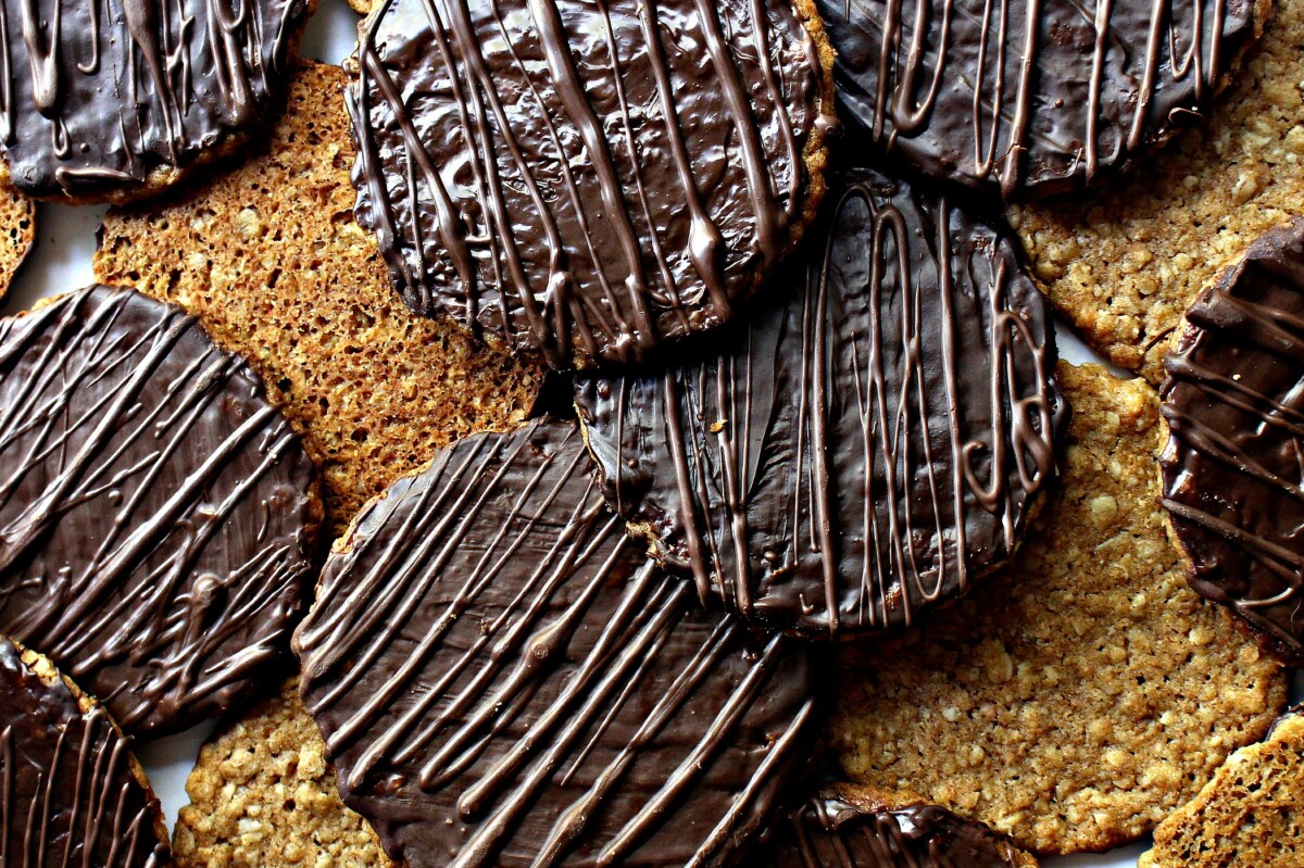 Closeup of chocolate coating on cookies with zigzags of chocolate on top.