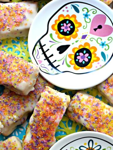 Bars of iced raisin nut cookies with colorful sugar sprinkles.