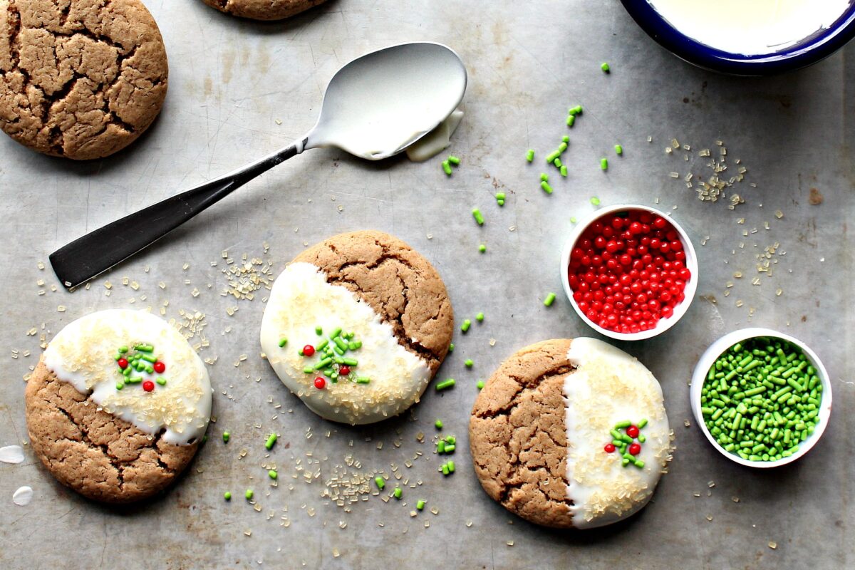 Gingerbread Spice Cookies with melted white chocolate and sprinkles.