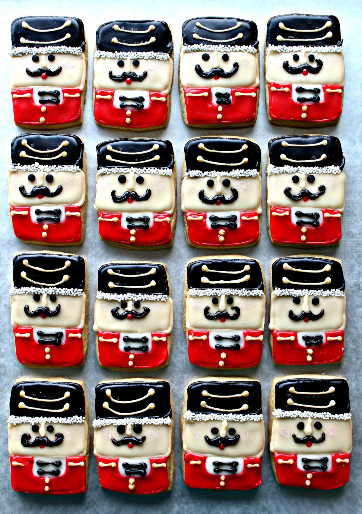 Nutcracker Sugar Cookies decorated in red and black to look like soldiers.