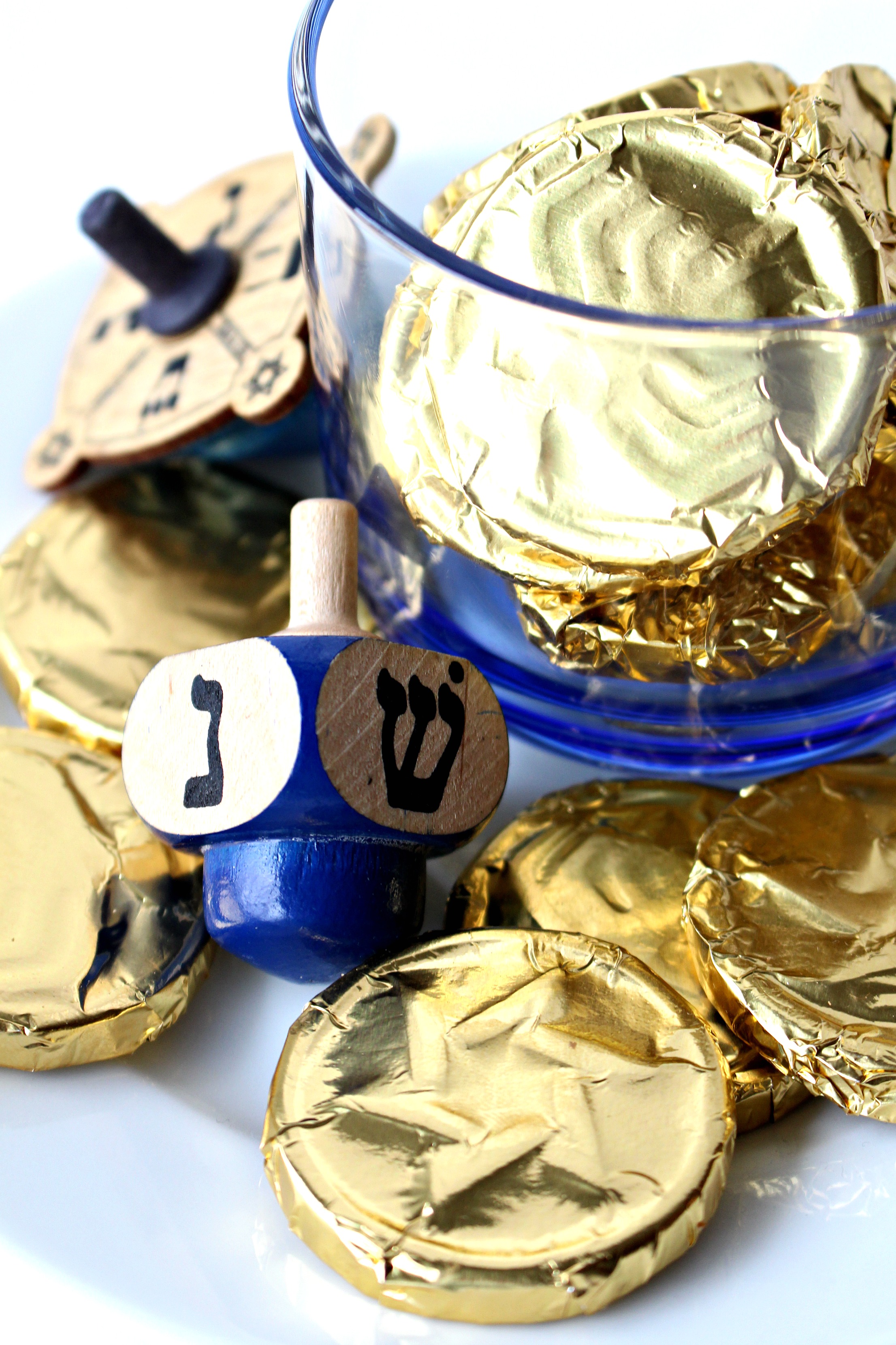 Gold foil wrapped chocolate coins with a blue dreidle