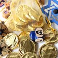 Gold foil wrapped Homemade Chocolate Coins (Hanukkah Gelt) with small, wooden dreidels