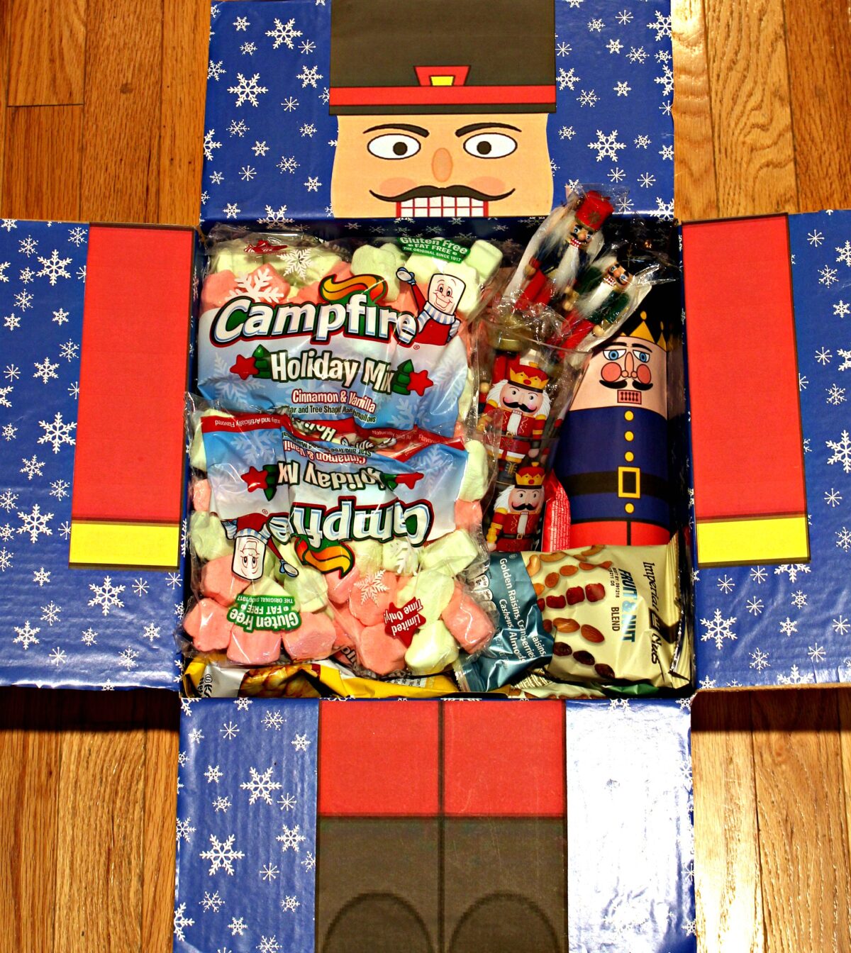 Nutcracker Care Package box decorated like a nutcracker soldier and filled with nutcracker themed items.