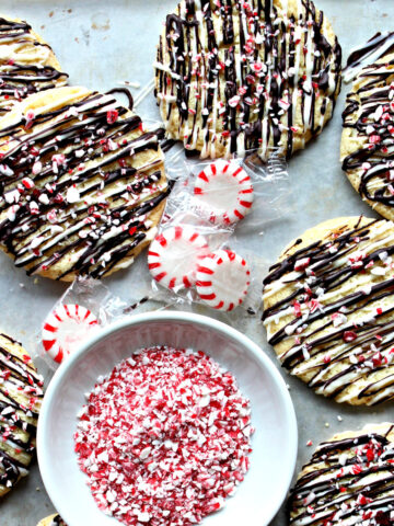 Cookies with chocolate drizzle and peppermint bits.