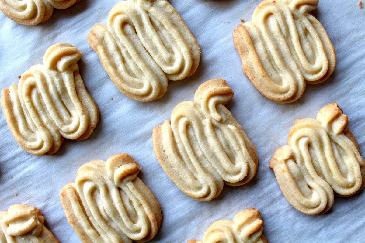 Butter cookie dough piped in a W shape for each dragon cookie.