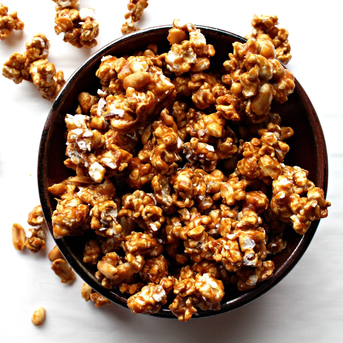 Caramel coated popcorn clusters with caramel coated peanuts.