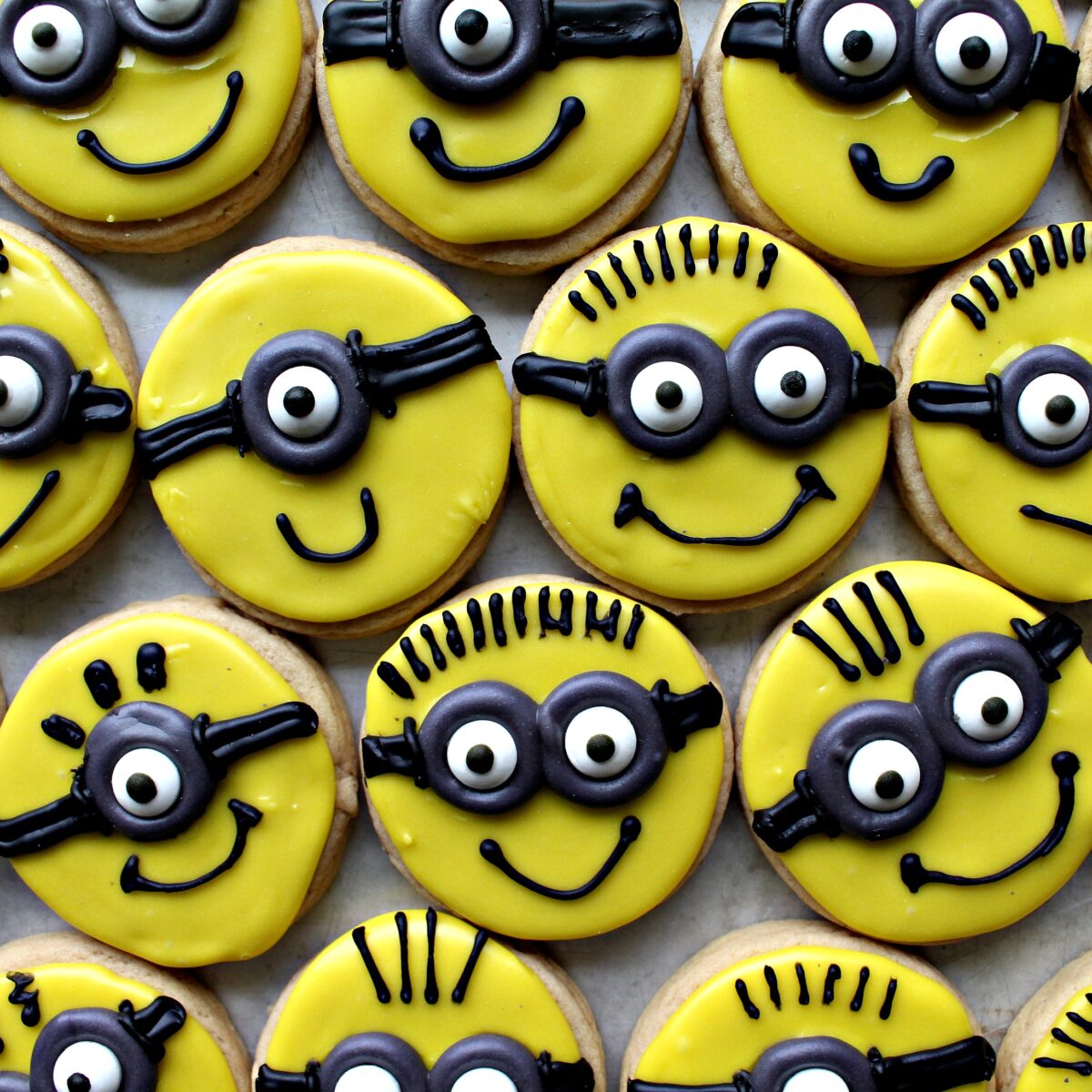 Minion Sugar Cookies  with a variety of one eyed and two eyed faces.