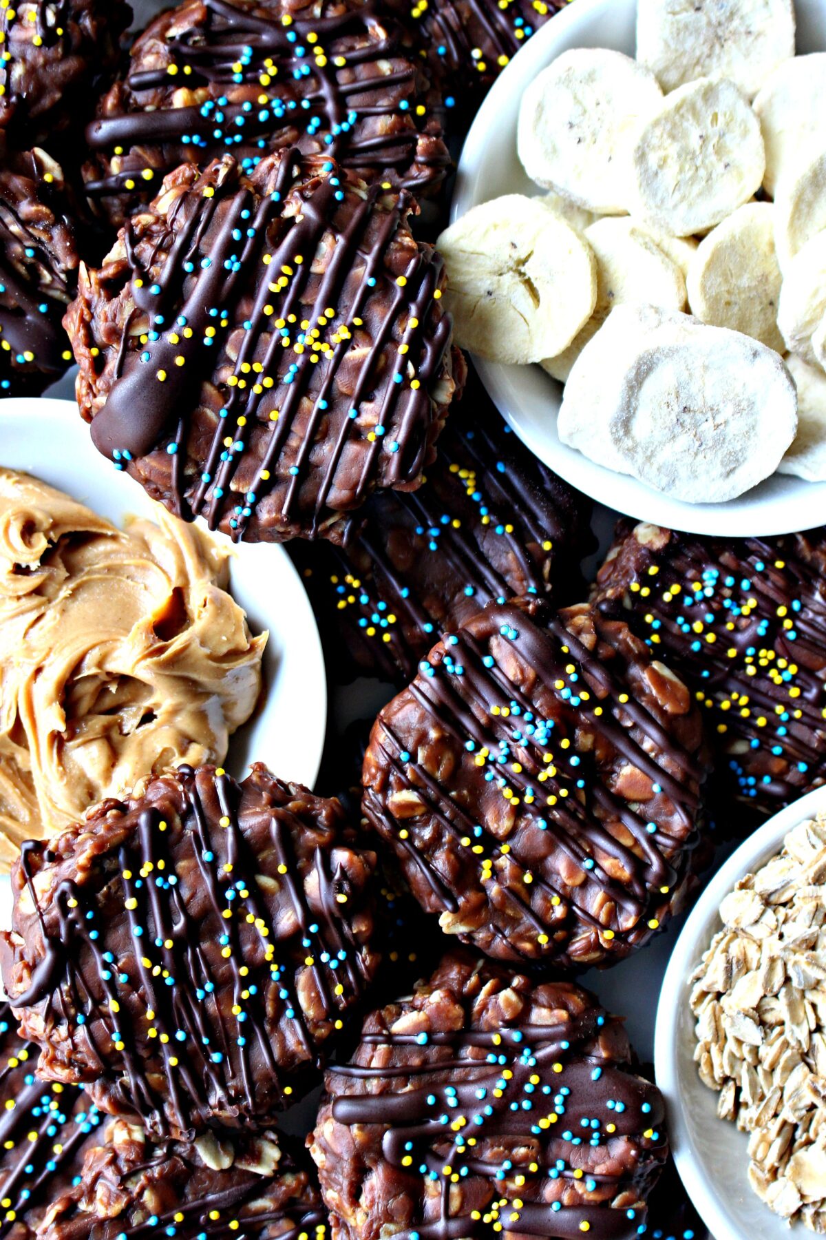 No-Bake Chocolate Peanut Butter Banana Cookies with bowls of freeze dried banana, peanut butter, and oats.