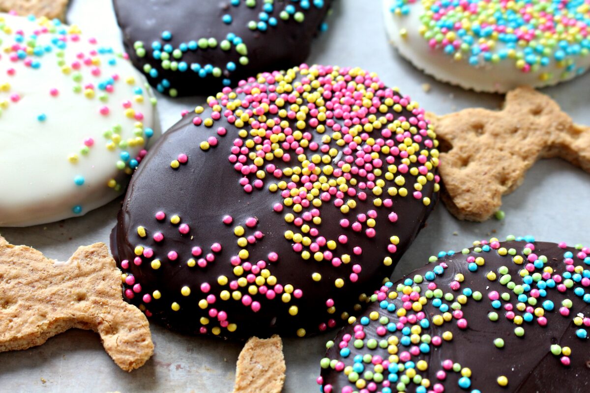 Dark chocolate covered graham cracker  with pink and yellow sprinkles.