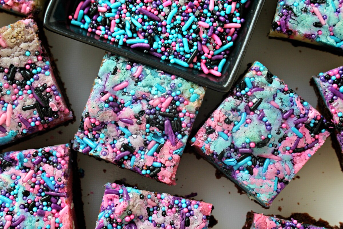Brownies closeup of colorful pink, blue, and purple top with sprinkles.