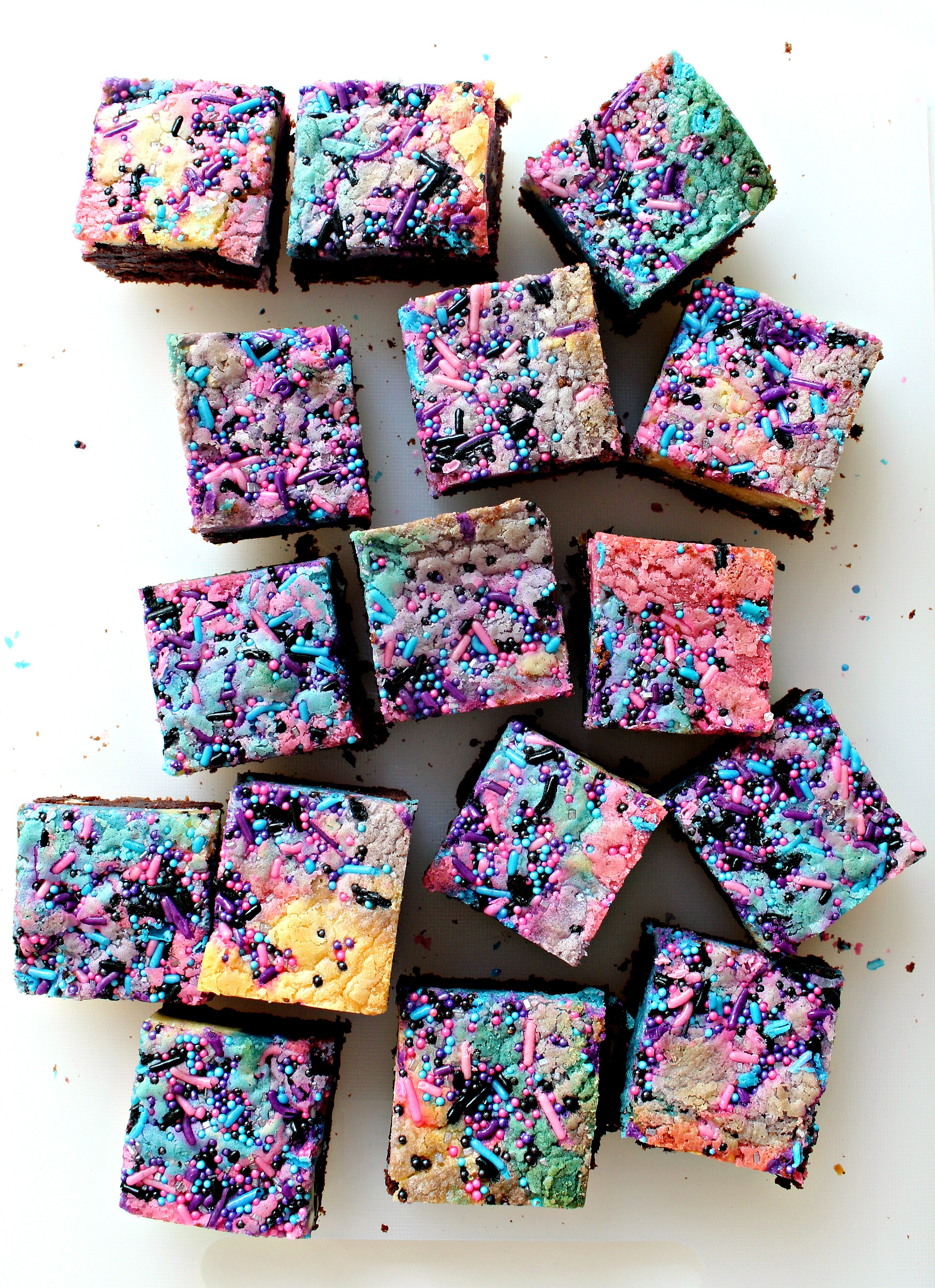 Galaxy Brownies with topped with swirls of pink, blue and purple blondie and sprinkles.