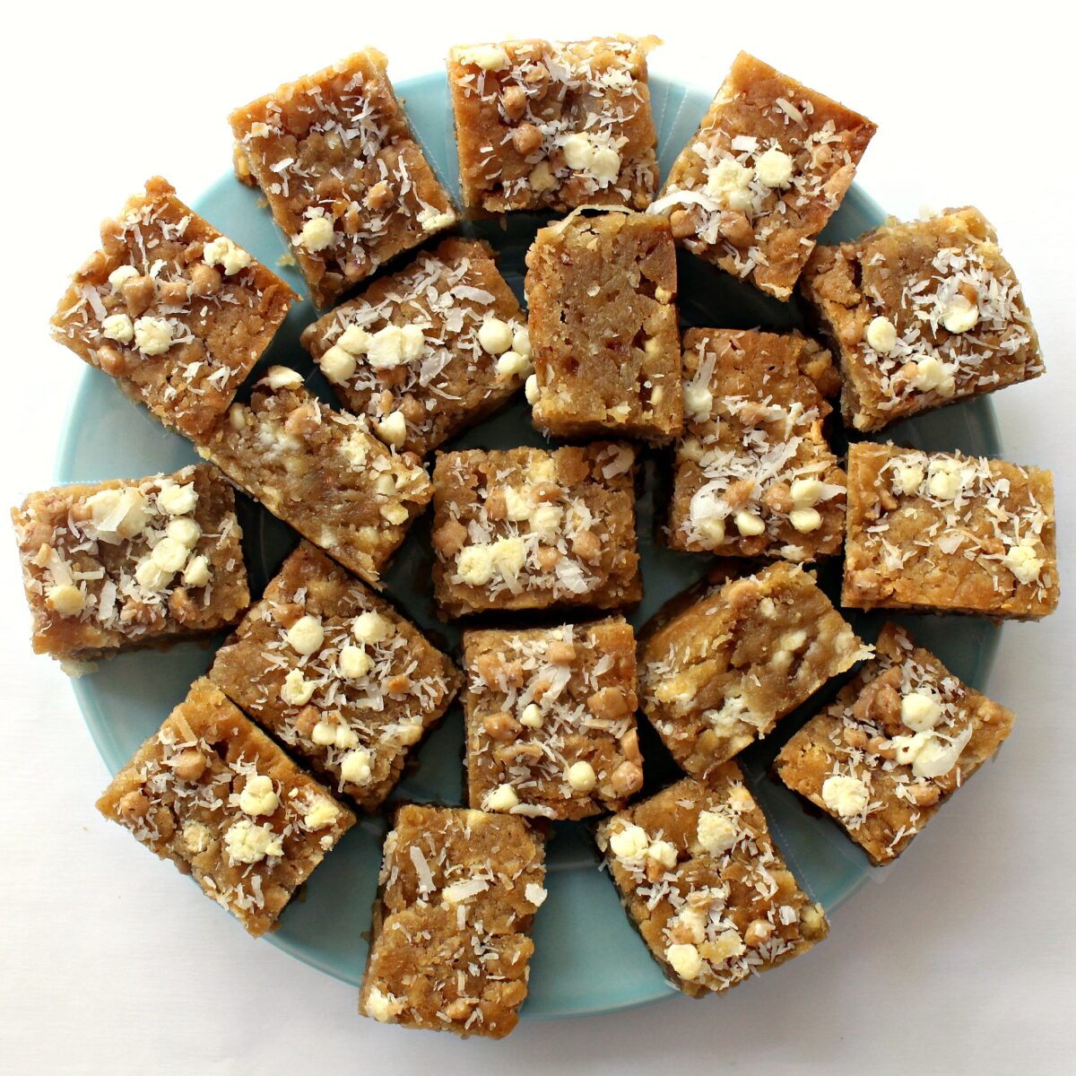 Coconut Blondies on a blue serving plate.