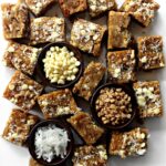 Squares of chewy Coconut Milk Blondies full of shredded coconut, white chocolate chips and toffee bits.