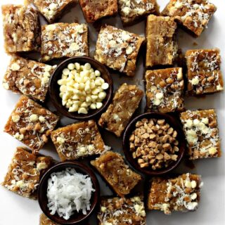 Squares of chewy Coconut Milk Blondies full of shredded coconut, white chocolate chips and toffee bits.
